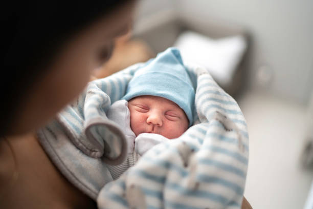 Women holding and looking at her godson at hospital